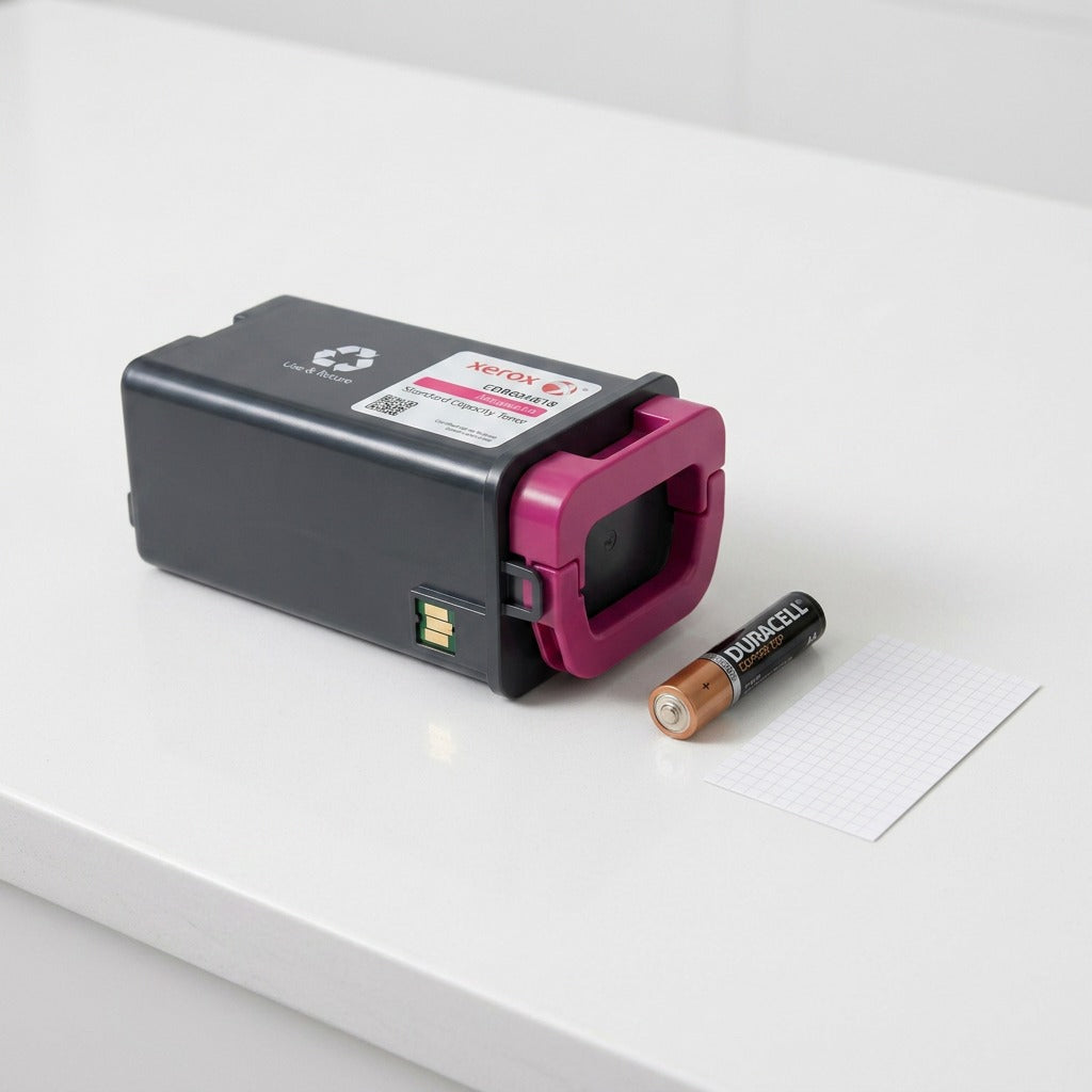 Scale reference photo: Magenta Xerox toner cartridge next to a standard AA battery.