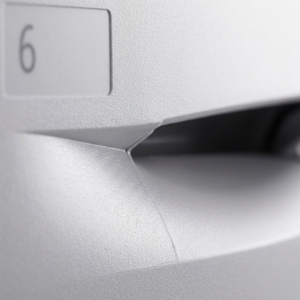 Extreme macro detail of the light gray plastic texture and handle mold seam on the Xerox feeder drawer.
