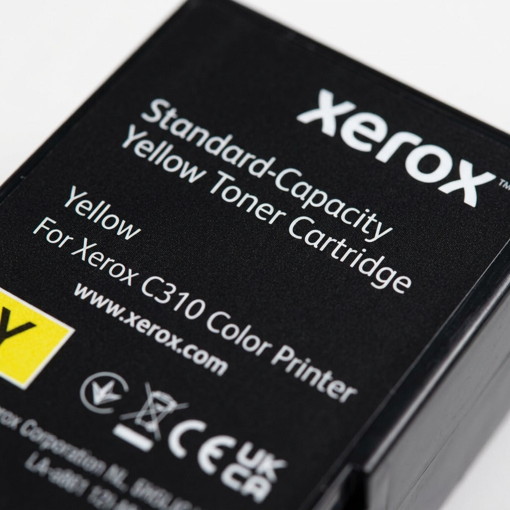 A macro photograph focuses on the fine detail of the contacts and label on the black toner cartridge body.