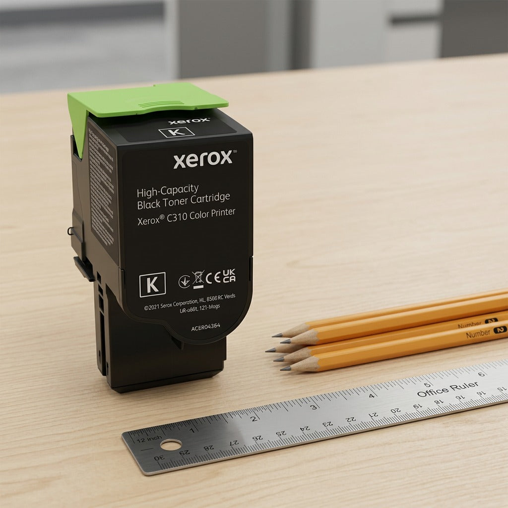 A scale reference photograph showing the Xerox C310 black toner cartridge next to a US quarter.