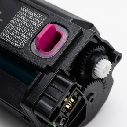 Extreme macro image focuses on the magenta chip contacts and gear on the Xerox print cartridge.