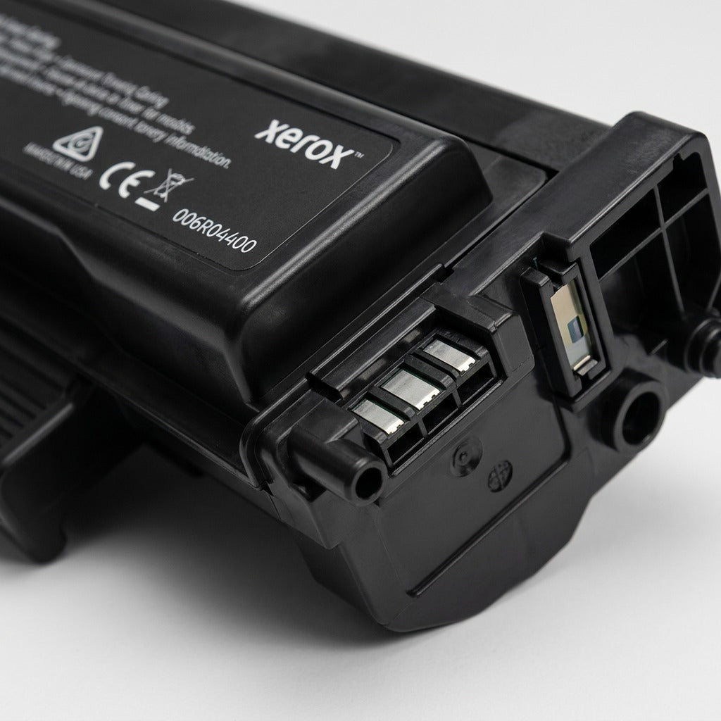 Extreme close-up of a Genuine Xerox Black High Capacity Toner Cartridge, highlighting a precise end connector and the matte black texture.