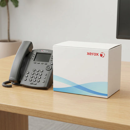 Xerox branded box placed beside a standard desktop office telephone to illustrate physical scale.