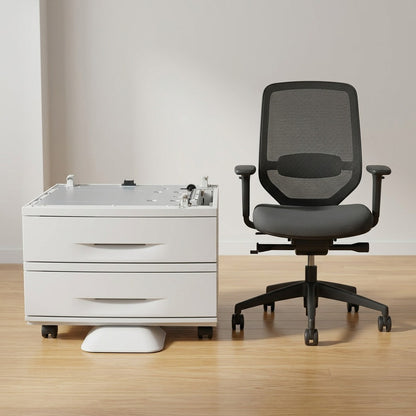 A scaled comparison of the Xerox WorkCentre stand with two paper trays next to a standard office chair.