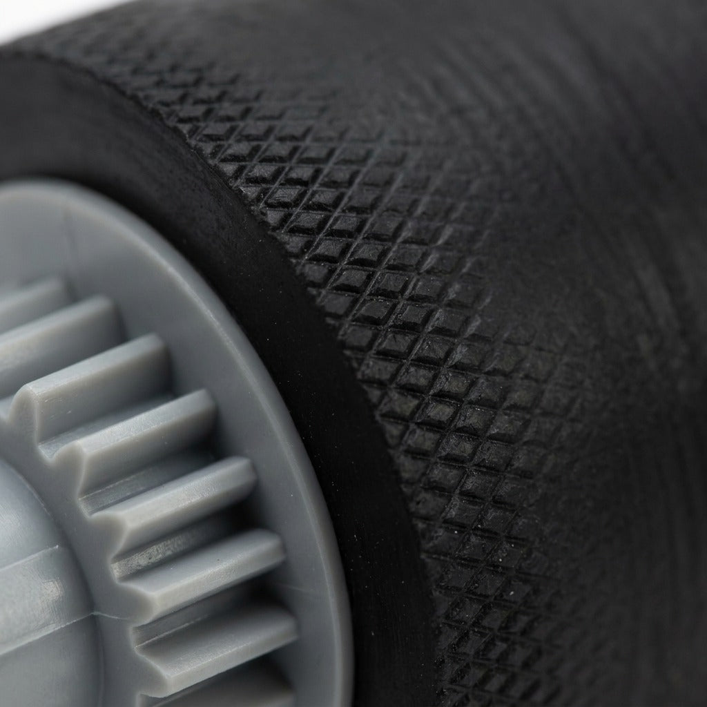 Macro view displays the textured black rubber surface and detailed gear teeth of the Xerox feed roller.