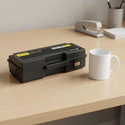 Scale photo showing the Xerox yellow toner cartridge beside a standard mug on a wooden desk.