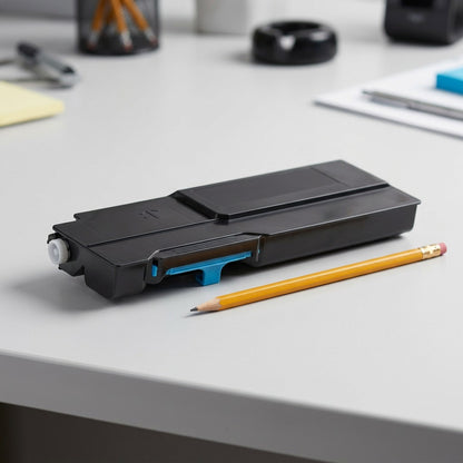 A photograph of the Xerox 106R03526 cyan toner cartridge next to a pencil for scale.