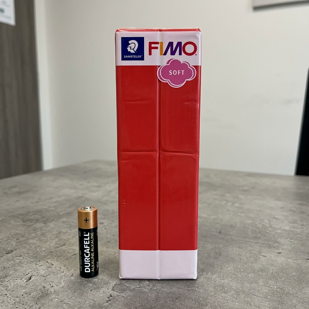 Scale comparison: FIMO 454g block next to a standard AA battery.