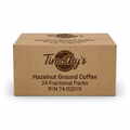 A high-resolution, centered view of the brown Timothy's Hazelnut Ground Coffee shipping box, featuring dark brown logo and text, against a pure white background.