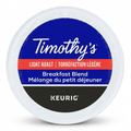 A professional, high-resolution product photograph showing the Timothy's Breakfast Blend K-Cup as seen in image_0.png, resting horizontally. The entire circular top label is visible, replicating the exact 'Timothy's' and 'Keurig' branding, color bands, and dual-language product descriptions for content and roast. It has a clean, natural shadow on a pure white background, showcasing all features sharply.