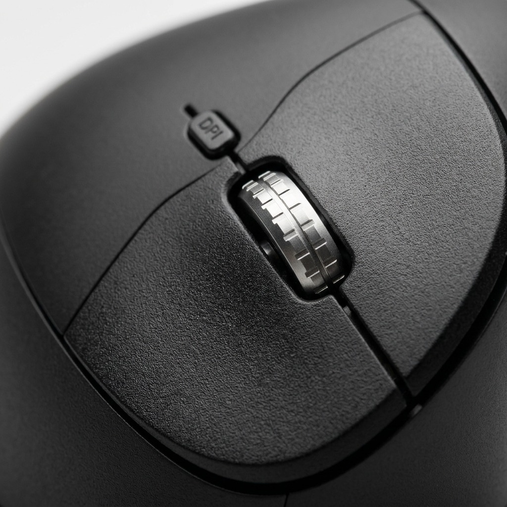 A macro photograph of the metallic scroll wheel and button texture on a vertical wireless mouse.