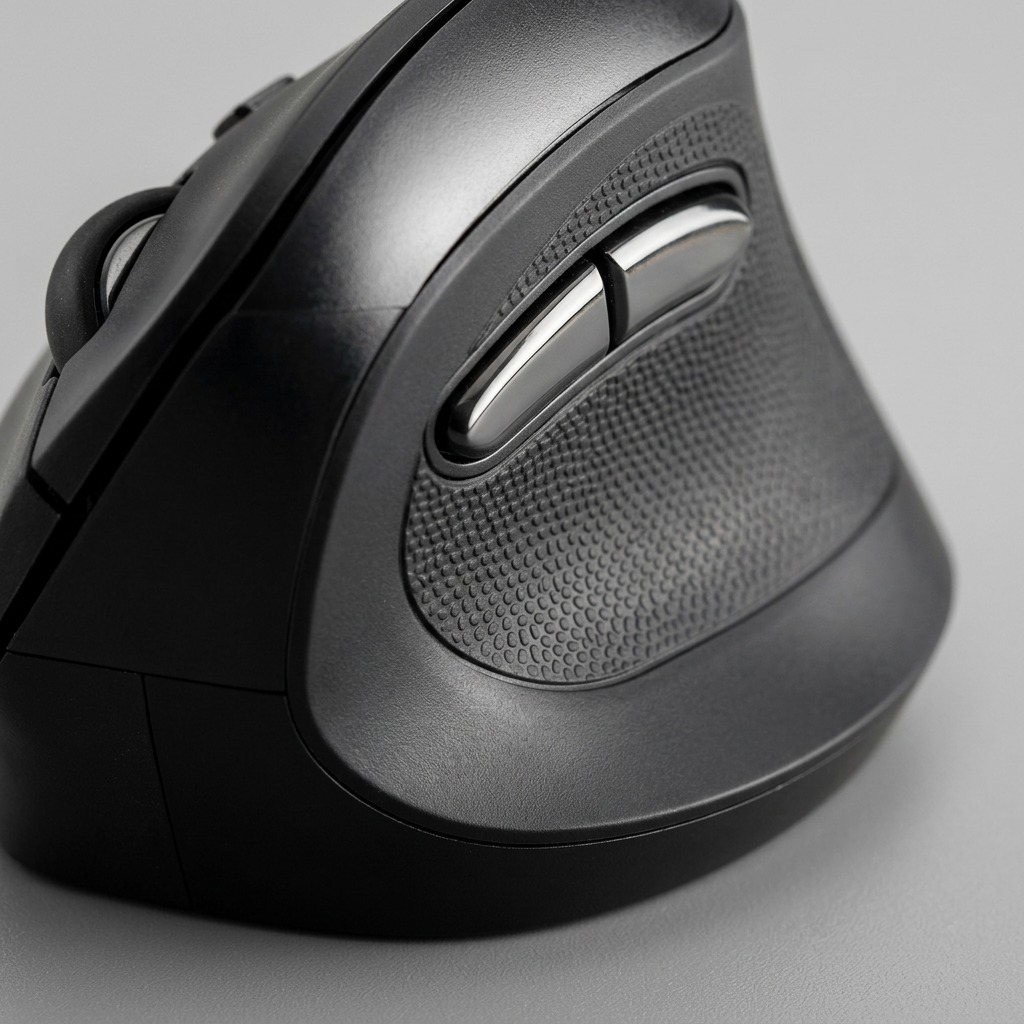 Macro detail of the Kensington vertical mouse showing thumb groove texture and side buttons.