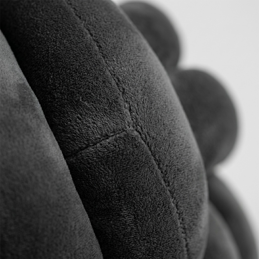 Extreme close-up macro view showing soft velvet texture and a precise seam on the fdmt Granite Cuddle Ball.